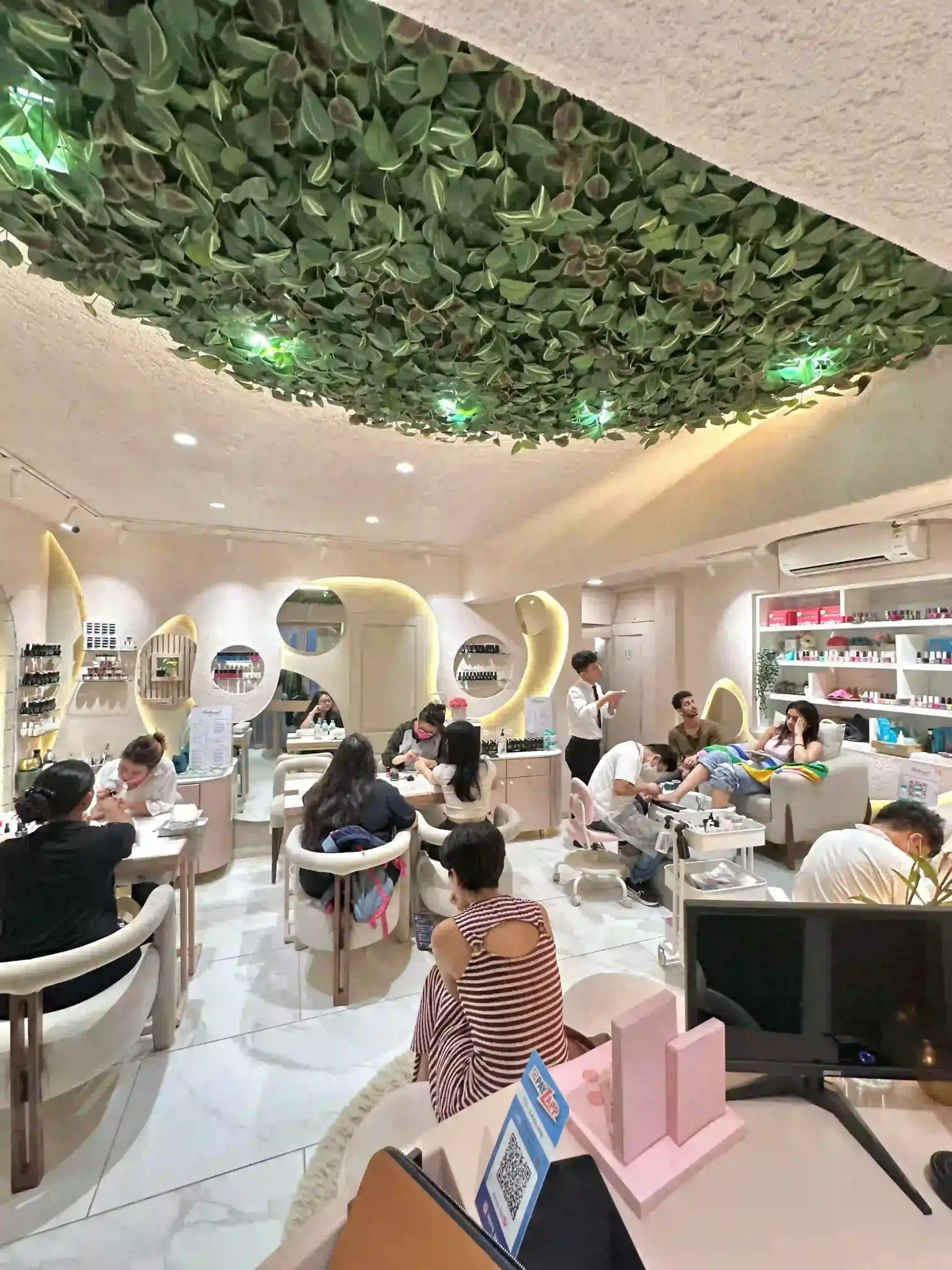 Nail technician with a client at Bellissimo